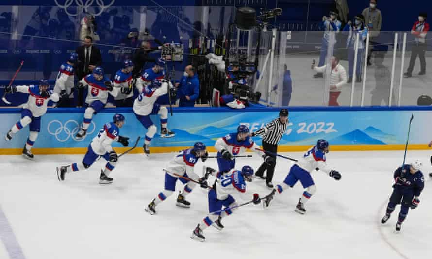 Slovakia run on to the ice to celebrate their victory.