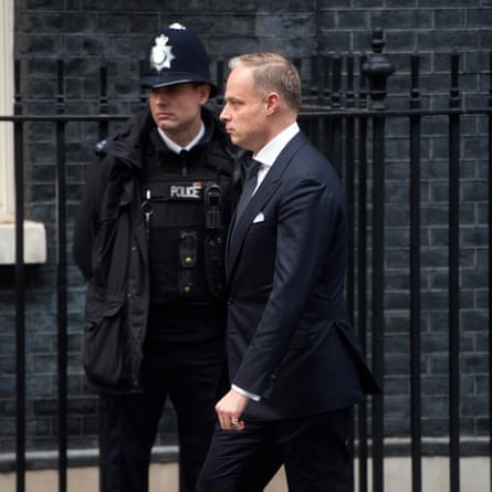 The Hungarian ambassador in the UK, Kristóf Szalay-Bobrovniczky, walking past a police officer in Downing Street.