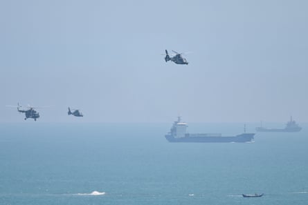 Chinese military helicopters fly over Pingtan Island, one of the closest points to Taiwan in mainland China
