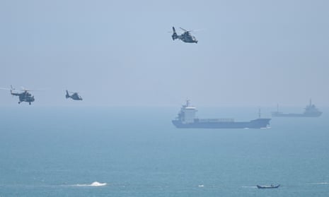 Chinese military helicopters fly past Pingtan island, one of mainland China's closest point from Taiwan, ahead of massive military drills off Taiwan.
