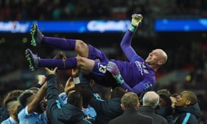 Manchester City’s goalkeeper Willy Caballero is lifted by his team-mates after wining the penalty shoot out in the Capital One Cup Final.