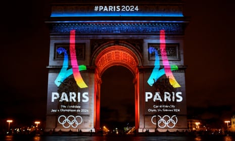 The Arc de Triomphe lit up with Paris 2024 logos.