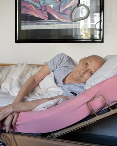Mr Oberländer looks brightly at the camera from his hospital bed at home