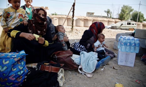 Iraqi women who fled the Isis-held Hawijah area wait to be screened near the northern Iraqi city of Kirkuk.