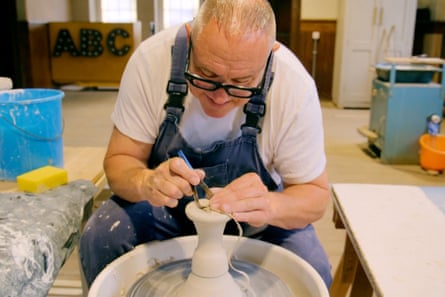 Keith working on a pot on his pottery wheel.