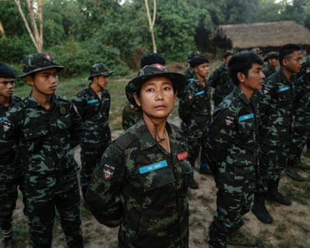 Ma Jack, 49, poses in uniform with other members of the National League for Democracy (NLD), the party of Aung San Suu Kyi