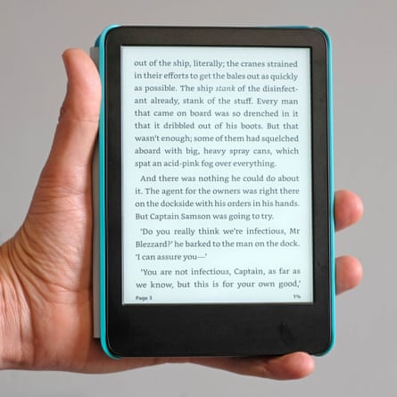 A hand holding an Amazon Kindle for Kids e-reader.