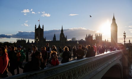 The sun sets on 16 September over Parliament and people on Westminster Bridge, which is closed to traffic
