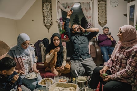 Salsabil, Lubna, Somar, Mousab (at the back) and their mother, Butheyna, at dinner in a home.