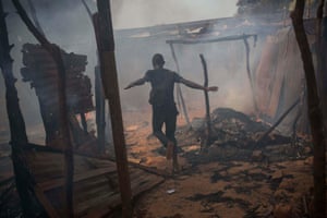 A man from the Christian community runs through a Muslim district of Bangui, where houses were looted and burned during the chaos that followed the resignation of President Michel Djotodia