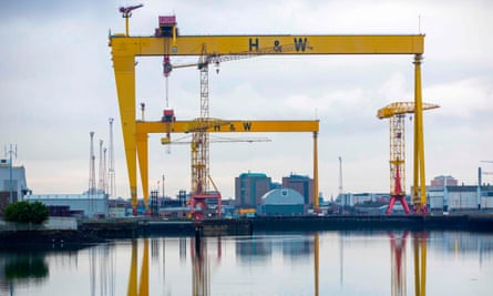 Two giant yellow cranes with two bases, shapewd like upside-down Us