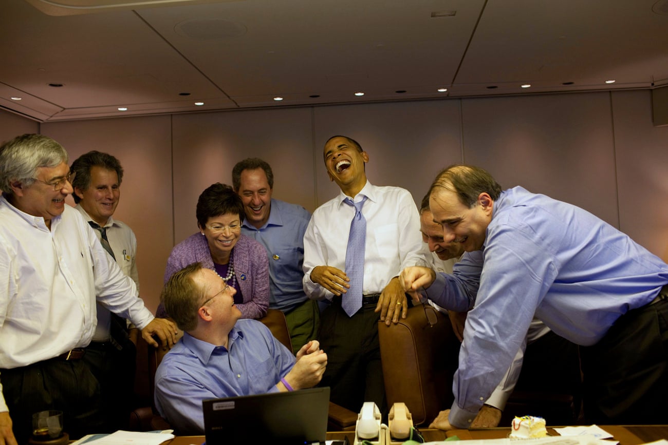 Nov 2009 Obama jokes with staff before the Summit of the Americas in Singapore