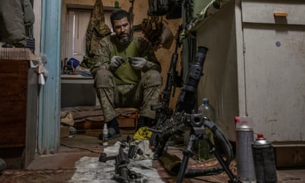 Massengo Djizlan, soldier from the 25th storm battalion cleaning a machine gun at his base near Avdiivka