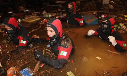 Algerian Civil Defense diving teams conduct search and rescue operations in a building submerged by floodwaters in Derna on Friday.