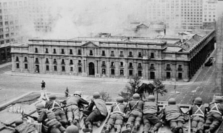 Soldiers supporting the coup led by Gen Pinochet take cover as bombs are dropped on the presidential palace