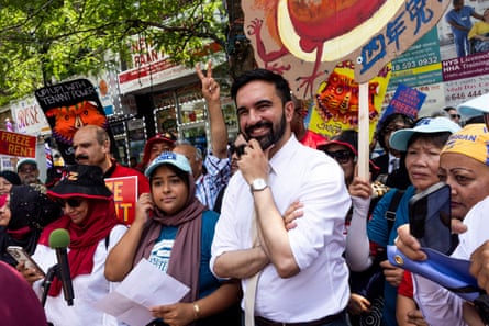 a man smiles while surrounded by a supporters