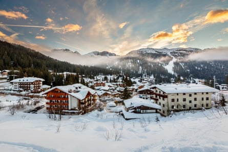 A ski resort in Italy soon after dawn with mist rising
