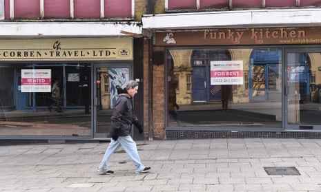 A man walks past two empty shop on March 15, 2021, in Burslem, England. 