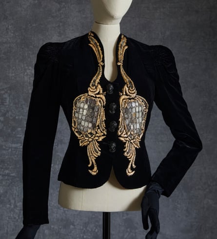 A black Elsa Schiaparelli evening jacket with embroidered rococo hand mirrors