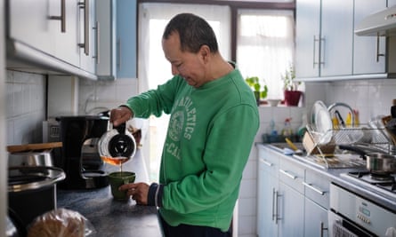 Cesar Franco pours a hot drink in his kitchen