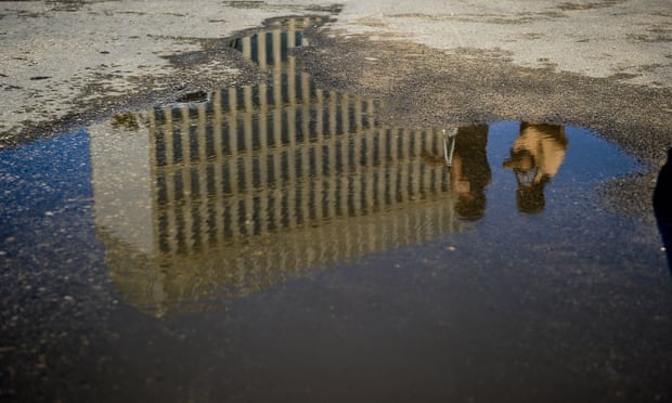 The US embassy in Havana reflected in a puddle. 