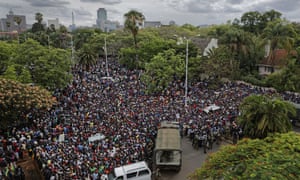 Protesters gather behind an army cordon on the road leading to State House.