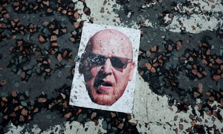 A mask of co-owner Joel Glazer is on the ground during protests in August 2022