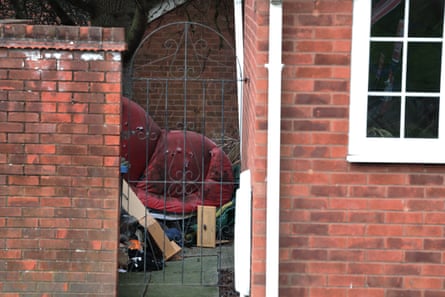 Discarded sofa and other rubbish seen in properties side passage.