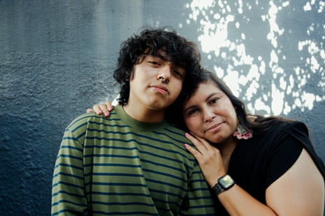 two people standing close and leaning their heads together