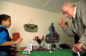 Grandfather & grandson playing table Subbuteo football game at Christmas time