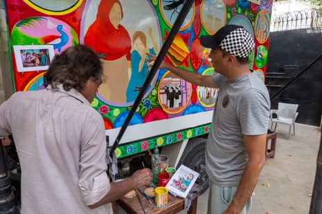 Ali Salman Anchan, right discusses the project with Shakeel Ahmed, a portrait artist at Phool Patti.