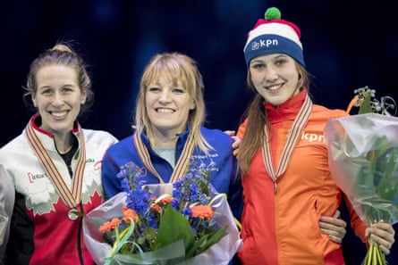 Elise Christie collects her gold medal in the 1,000m at the world championships in Rotterdam, where she also won gold in the 1500m and the overall title