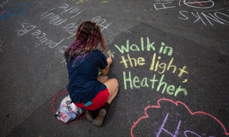 People write messages in chalk in memory of Heather Heyer.