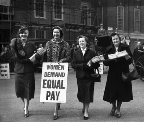 A black and white photograph of Barbara Castle in a street holding a banner saying Women Demand Equal Pay, while three other women stand with her holding papers
