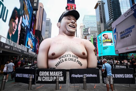 An inflatable caricature of Elon Musk in New York’s Times Square with the words’Spacex’s Grok makes AI porn’