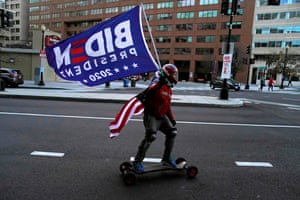 Washington, DC, US: a skateboarder flies a Biden flag before the inauguration ceremonies