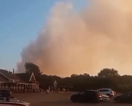 Smoke rises from the fire