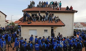 Israeli police try to evacuate supporters of settlements in the occupied West Bank.
