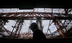 A worker walks through the Zenit Arena construction site in St Petersburg, Russia in 2015.