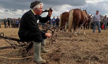 A man enjoys a bottle of ‘real Guinness’ in County Kildare after the European ploughing championships in 2010.