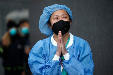 A nurse stands outside NYU Langone hospital in New York.
