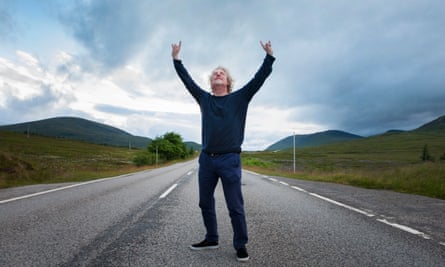 Olaf Furniss in the middle of a road, arms aloft.
