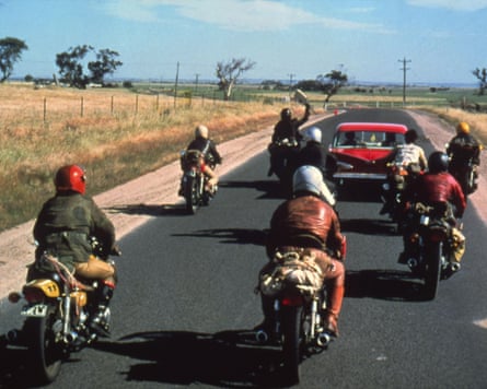 A biker gang rides down a desert road
