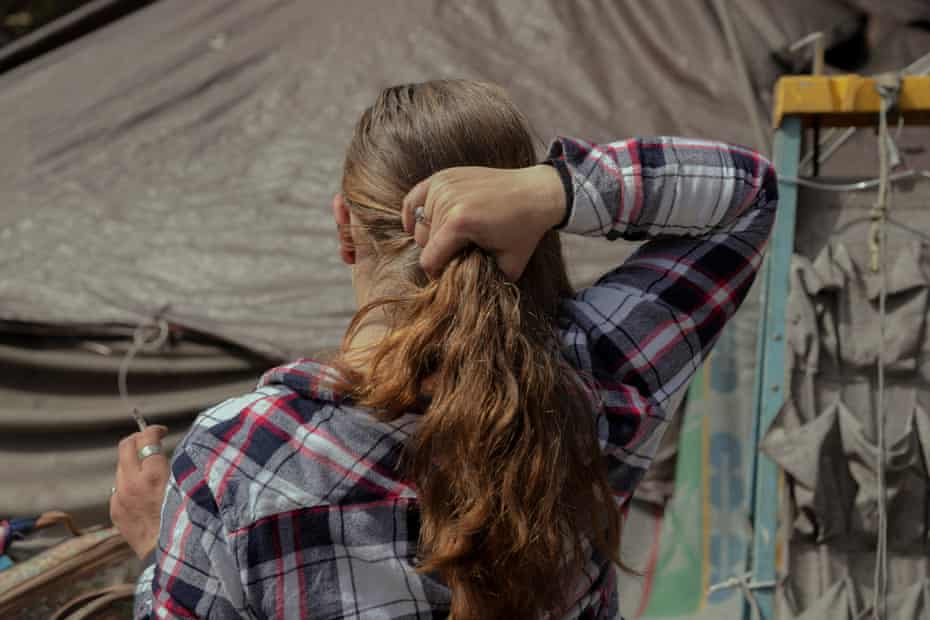 A woman seen from behind adjusting her hair