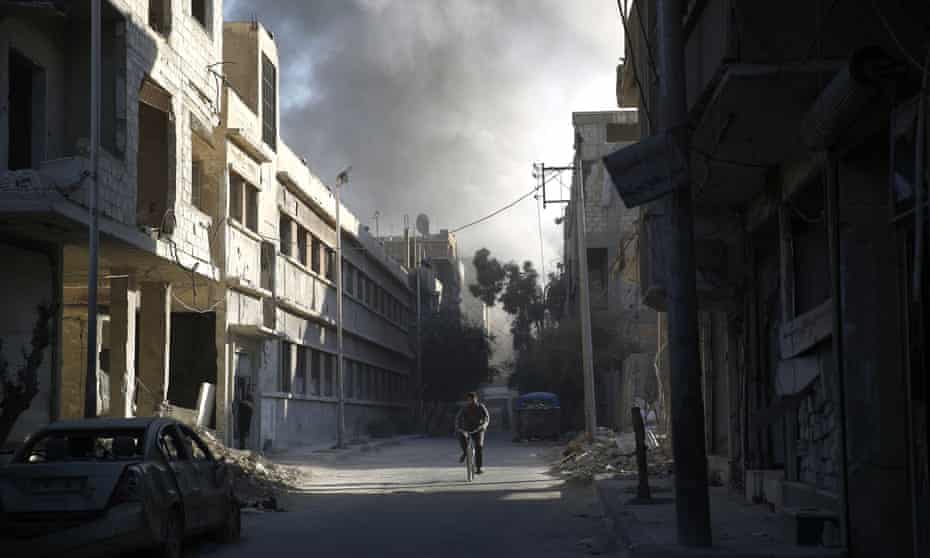 A cyclist amid the rubble in Douma, east of Damascus, following a reported air strike by Syrian government forces