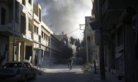 A cyclist amid the rubble in Douma, east of Damascus, following a reported air strike by Syrian government forces
