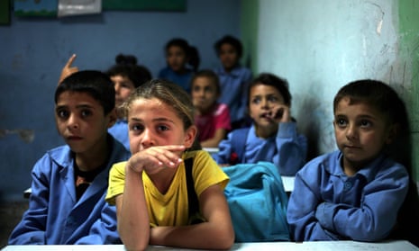 Syrian refugee students sit in their classroom at a Lebanese public school.