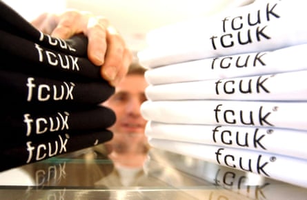 A man reaching for a stack of FCUK T-shirts