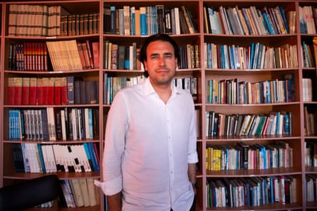 Vlado Mirosevic Verdugo stood in front of a large bookcase