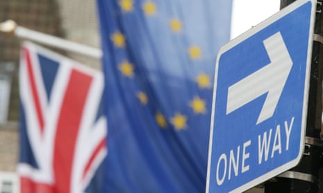 A road traffic sign is in front of the Union Jack and the European Union flag hanging outside Europe House in Smith Square, London